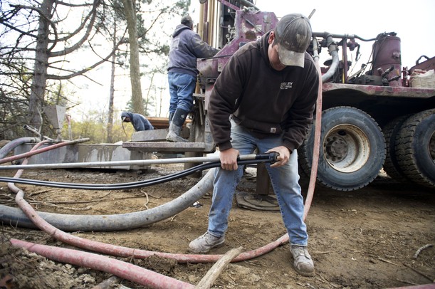 Cribley Drilling Company worker Matt Wing works in Paul Hickman's backyard as they crew installs a geo-thermal well. Melanie Maxwell I AnnArbor.com